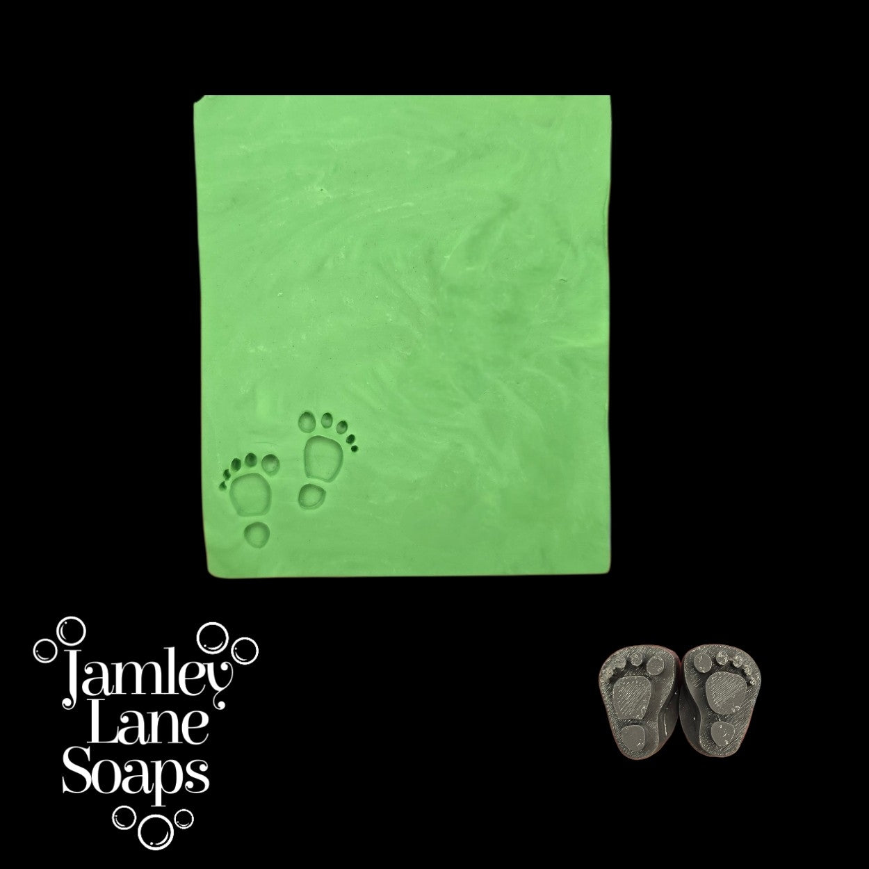 Green soap 7cm wide bar with footprints and two gray stamps that left the impression on a black background, featuring Jamley Lane Soaps branding.