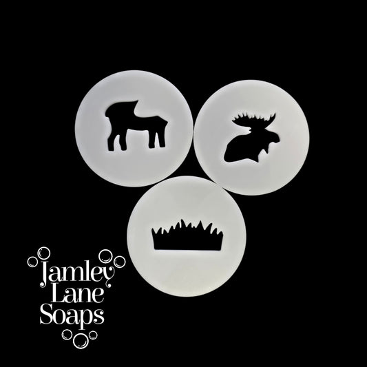 Three circular discs with animal silhouettes on a black background, featuring the brand 'Jamley Lane Soaps'.