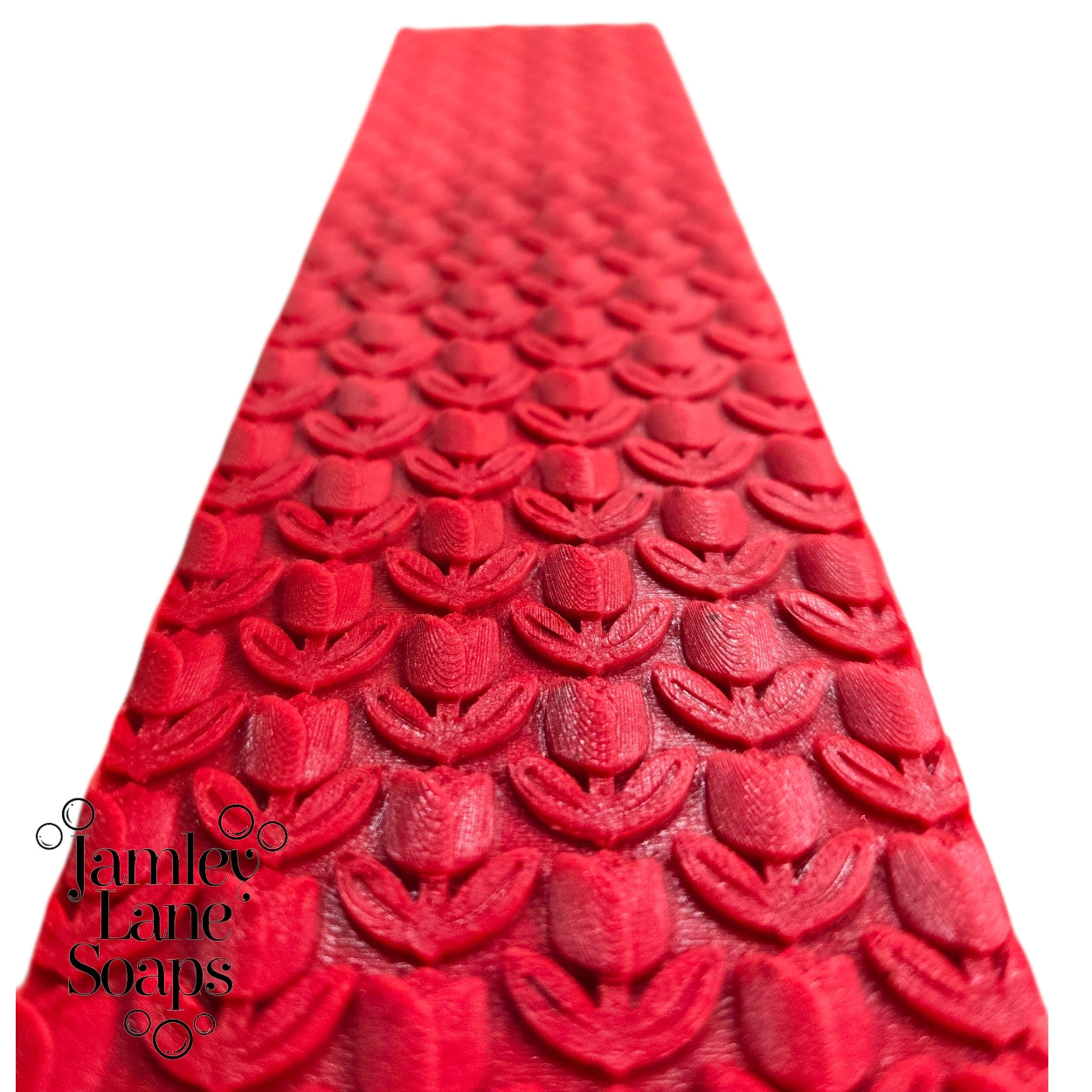 repeating tulip pattern up close on a red melt and  pour soap top on a white background, branded with 'Jamley Lane Soaps'.