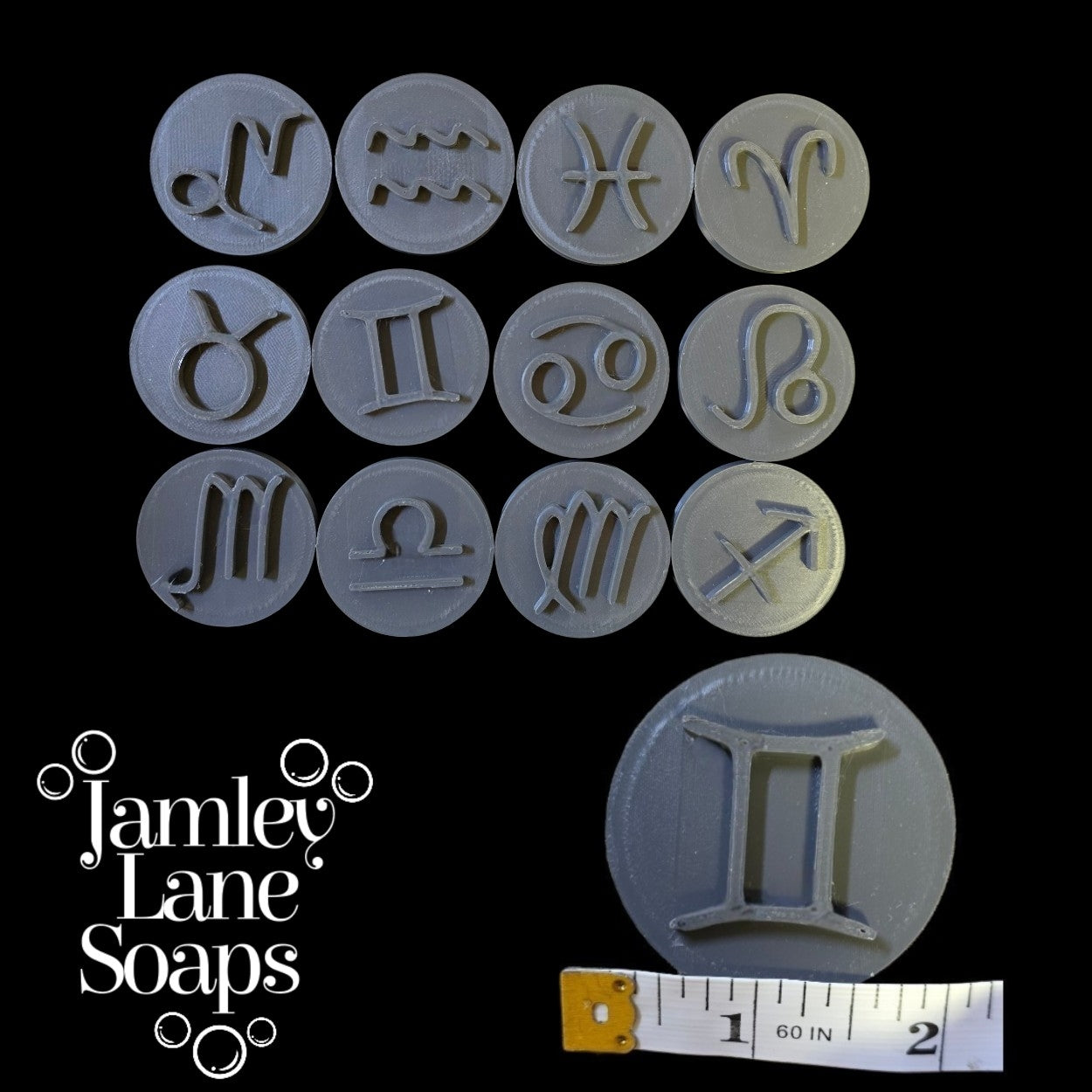 Set of zodiac symbol stamps with a ruler for scale, branded 'Jamley Lane Soaps'.