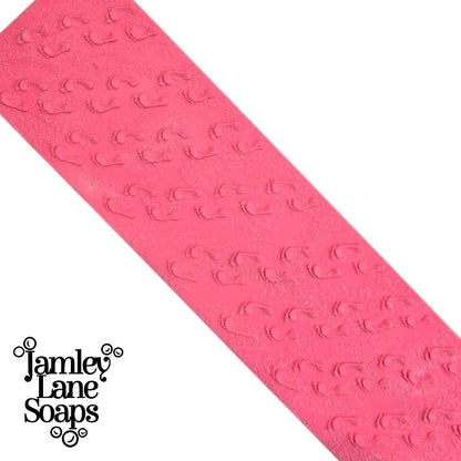 pink textured artisan polymer impression mat featuring a repeating embossed footprint pattern