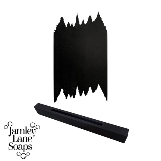 Black soap scraper in a tree line silhouette on a white background, featuring the brand 'Jamley Lane Soaps'.