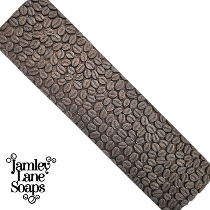 a full length soap loaf top only which shows the pattern created by the coffee bean impression mat