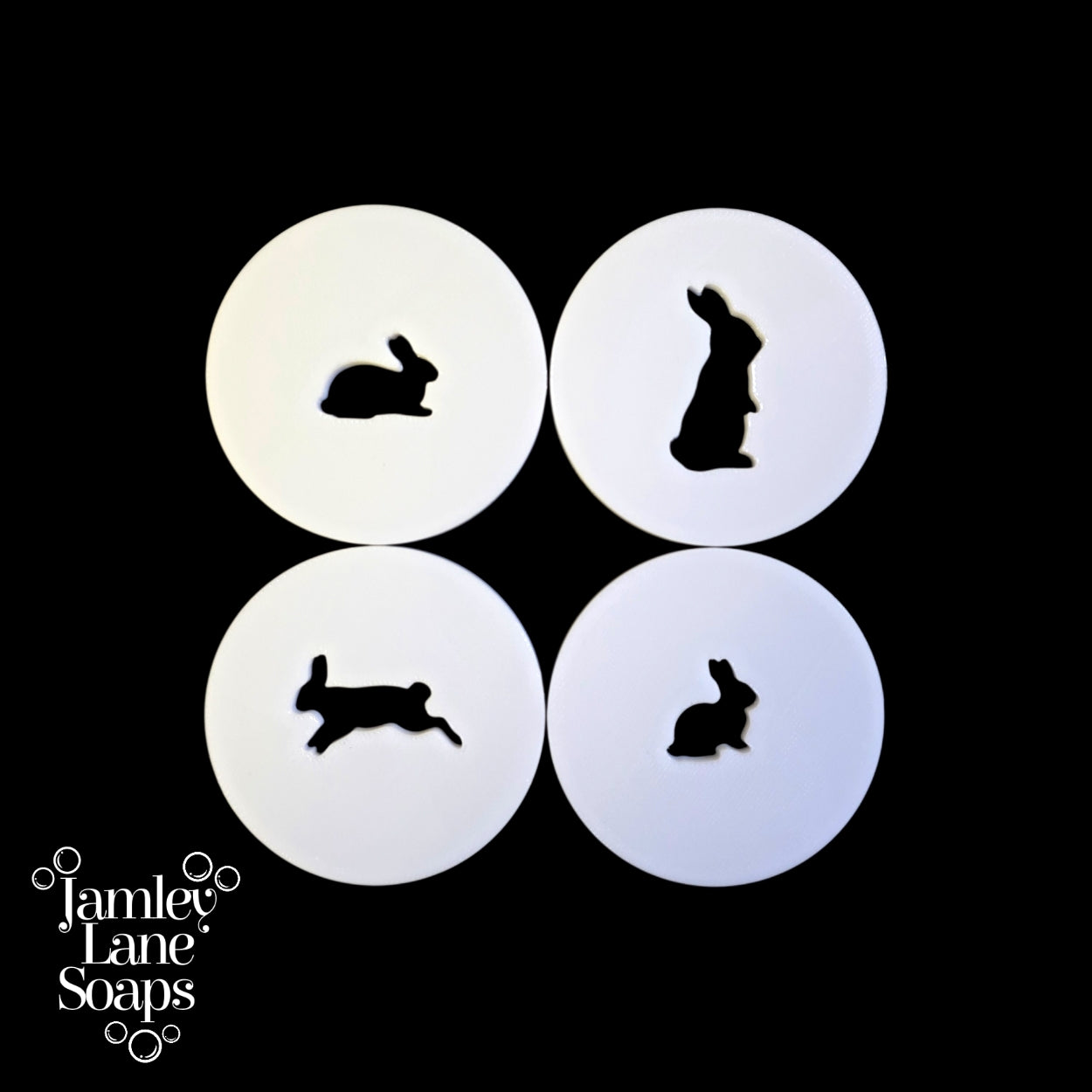 Four white circular discs with black rabbit silhouettes on a black background, featuring Jamley Lane Soaps branding.
