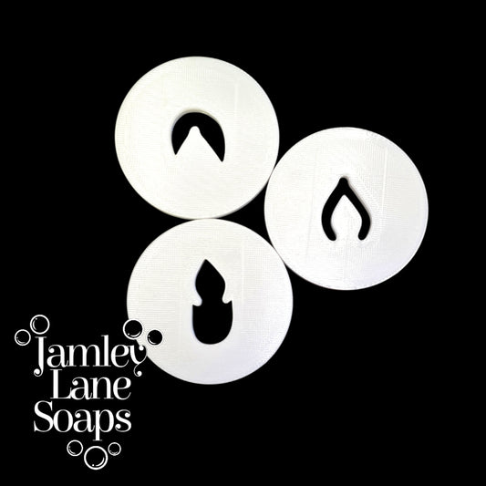 Three white extruder discs that make up a flip flop sandal on a black background, featuring the Jamley Lane Soaps logo.