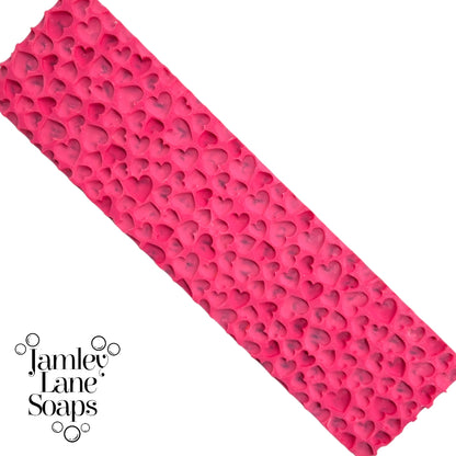 Pink artisan polymer soap mat with heart patterns on a white background, branded with 'Jamley Lane Soaps'.