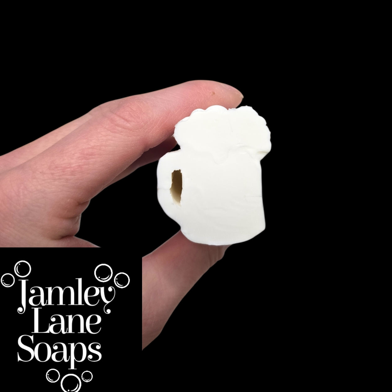 Hand holding a white soap shaped like a mug with 'Jamley Lane Soaps' branding.